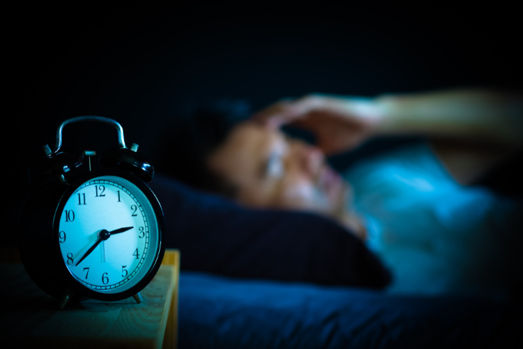 cannabis for insomnia person awake in bed