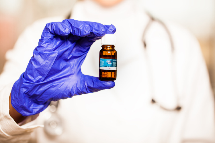 maryland medical cannabis program doctor holding vial